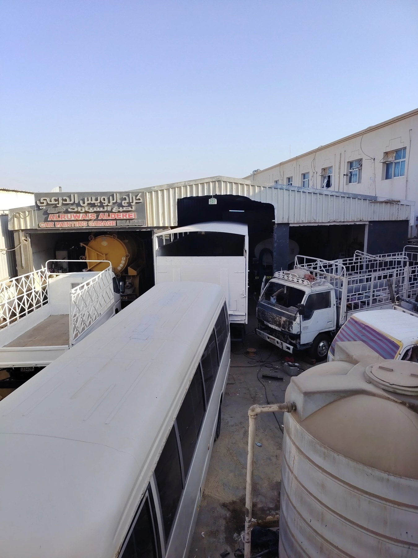 The BSRCA workshop yard in Al Ain — buses and trucks under restoration